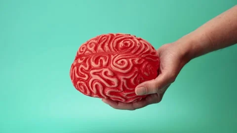 Hand with red brain against green background Stock Footage 292270601