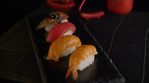 Hand with red chopsticks taking sushi Stock Footage 69720521