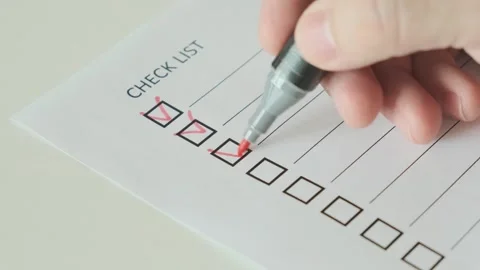 Hand with red pen marking on checklist box on paper Stock Footage 265880131