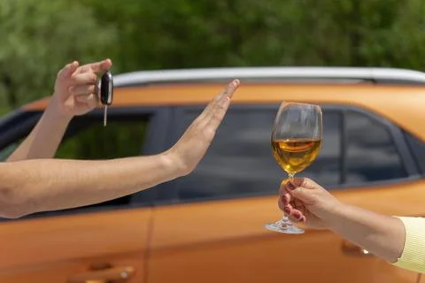 Hand refusing alcohol showing car key as gesture of don't drink. Designated d Stock Photos