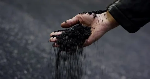 Hand Releasing Rubber Granulate, Falling Crumb Over Dark Background, Close Up Stock Footage 340680578
