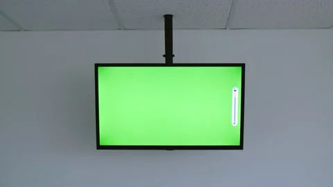 Hand with remote control. Change volume on TV with green screen. Stock Footage 157876497