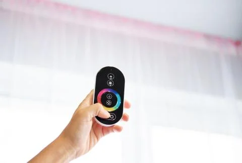 Hand with Remote control on off. LED light Remote Control. LED illumination Stock Photos