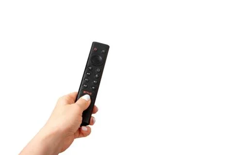 Hand with a Remote Control Nvidia Sheild TV with Netflix Logo. isolated on wh Stock Photos