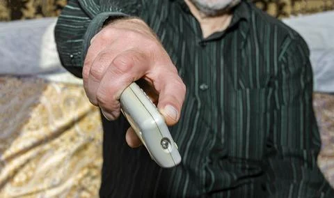 Hand with remote control Stock Photos