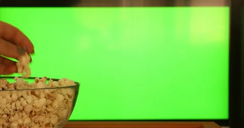 Hand with remote control pointing at modern chroma green screen TV 12 Stock Footage 129052839