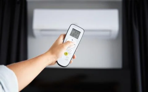 Hand with Remote control on off. Remote Control Directed on the Conditioner Stock Photos