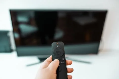 Hand with remote control. Streaming services and watching TV concept.. Stock Photos