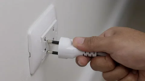 Hand remove Electric plug on socket. Electrical equipment, electrical wires and  Stock Footage 152754498