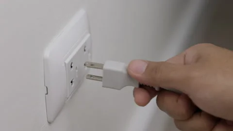 Hand remove Electric plug on socket. Electrical equipment, electrical wires and  Stock Footage 152754678