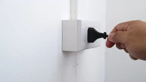 Hand remove Electric plug on socket. Electrical equipment. wrong or unsafe Stock Footage 171529431