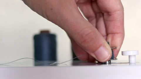 Hand remove thread bobbin from Sewing Thread Spooling  Stock Footage 319894751