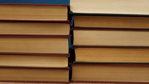 Hand removes books one by one on a blue background Stock Footage 120296177