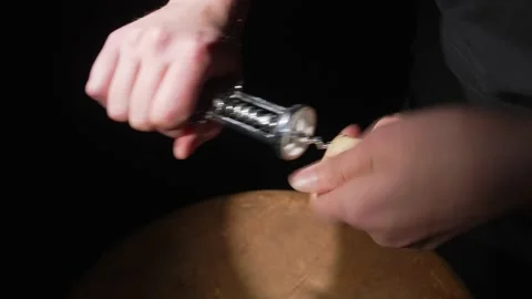 Hand removes cork from corkscrew Stock Footage 150527514