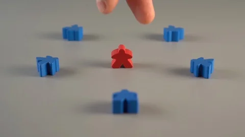 A hand removes a red shape from the surroundings of blue shapes Stock Footage 113970643