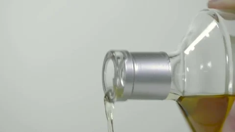 Hand removing cap from a  bottle of whiskey, and pouring Stock Footage 77601926