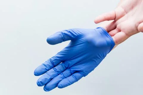 Hand removing correctly the second glove Stock Photos