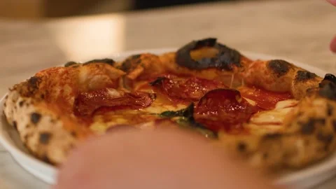 Hand Removing Fresh Neapolitan Pepperoni Pizza from Marble Restaurant Table Stock Footage 337281055