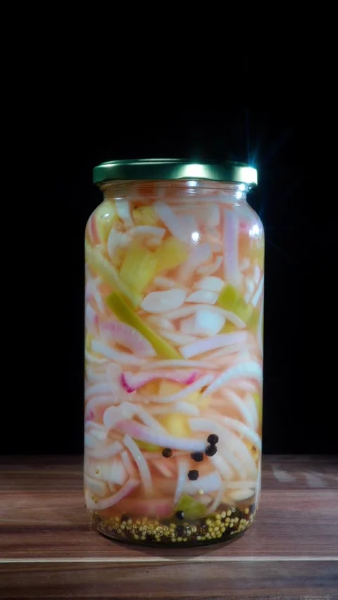 Hand Removing Jar Of Pickled Pineapple And Onions From Table Stock Footage 324769613