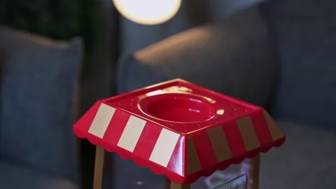 Hand Removing Lid From Red Mini Popcorn Machine Stock Footage 336643584