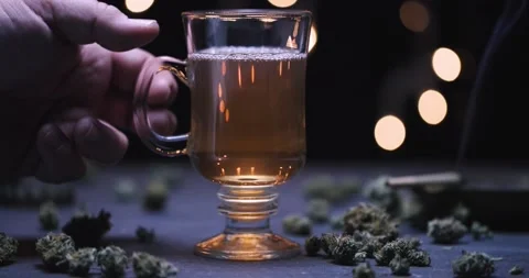 Hand Removing Marijuana Infused Tea 4k 120p Stock Footage 229010088