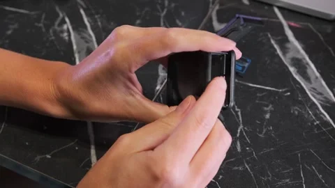 Hand removing memory card from action camera slot, close-up of storage access Stock Footage 333649690