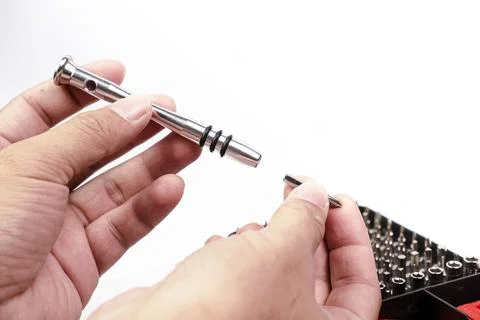 Hand is removing the precision screwdriver component Stock Photos