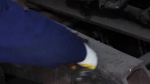 The hand of a repair worker is twisting, an old rusty nut, with a wrench. Video stock 124576478