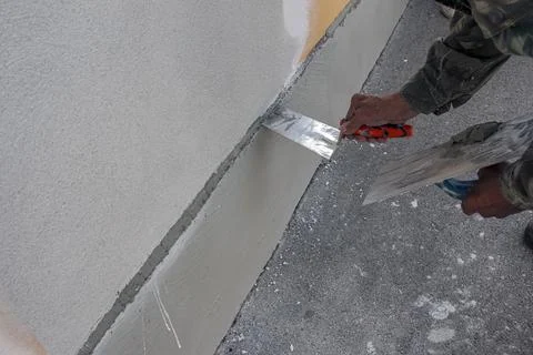 Hand Repairing Wall Surface with Putty Knife Stock Photos
