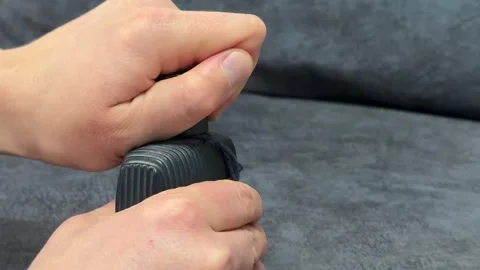 A hand repeatedly opens and closes the cap of a cologne bottle, capturing the Stock Footage 335074198