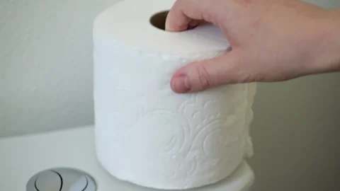 Hand replacing toilet paper roll in bathroom Stock Footage 329200038