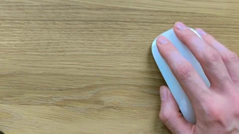 Hand resting on a computer mouse with copy space. Wooden desk background sh.. Stock Footage 342540814