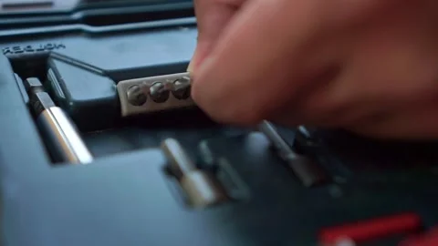 Hand returning screwdriver bit from tool box, workshop hardware organization Stock Footage 345293586