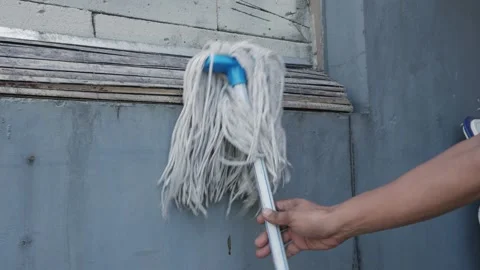 Hand Returning String Mop To Storage Close Up Stock Footage 340345069