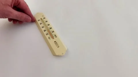 Hand Returns Beige Analog Thermometer on White Surface 動画素材 330051168
