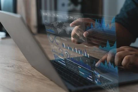 Hand reviewing a data analysis dashboard on a laptop with charts, graphs, m.. Stock Photos