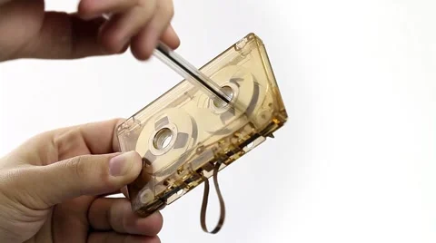 Hand-rewinding an old audio cassette with a pen Stock Footage 58655939