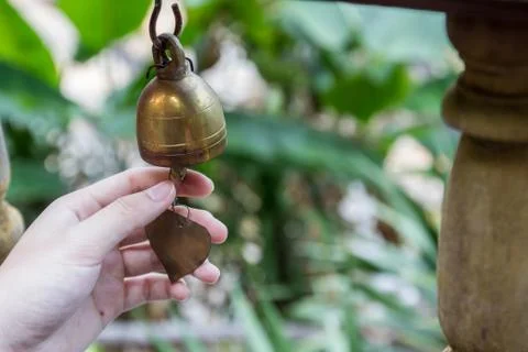 Hand ringing small thai style bell Stock Photos