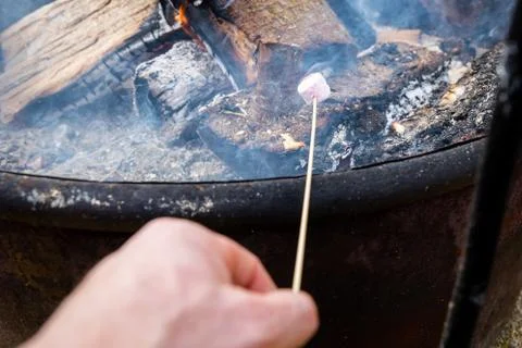 A Hand Roasting a Marshmellow Stock Photos