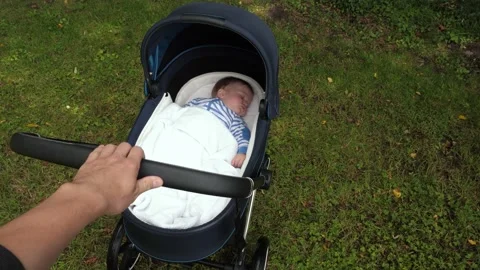 Hand rocks the stroller Stock Footage 310942601