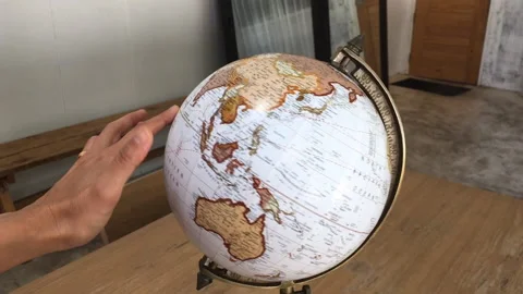 Hand roll retro globe item Stock Footage 136142484