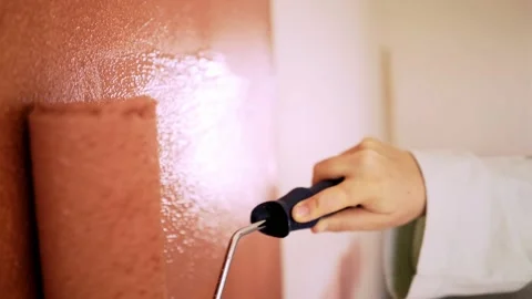 Hand with roller painting wall Stock Footage 145313375