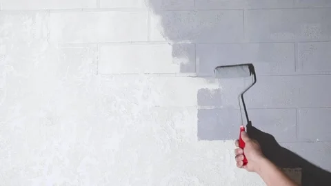 Hand with a roller paints the wall Stock Footage 225820134