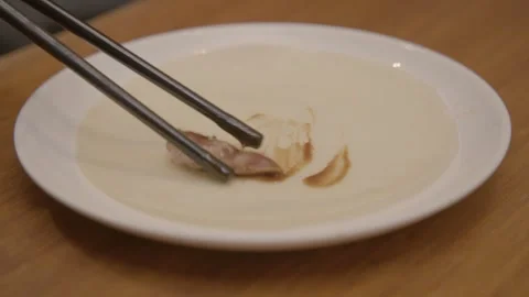 Hand Rolling Chinese Pancake Wrap with Meat and Sauce on Plate in Beijing Stock Footage 345902563