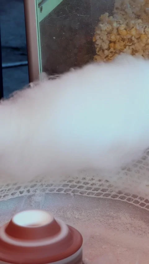 Hand rolling cotton candy in candy floss machine. Making candyfloss. Candy floss Stock Footage 316892930