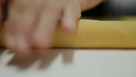Hand rolling dough with rolling pin on counter in kitchen Stock Footage 107569080