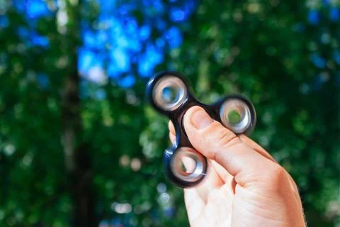 Hand with rolling spinner. Stock Photos