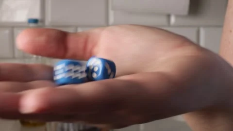 Hand rolls blue dice in soft light, chance symbolizing game and decision, c.. Stock Footage 320723227