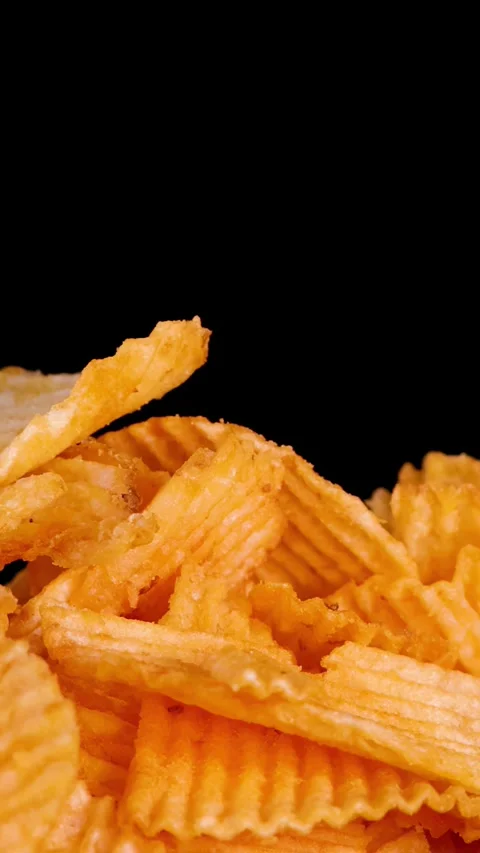 Hand Rotates and Picks Up Crispy Potato Chip Snack Stock Footage 321800976