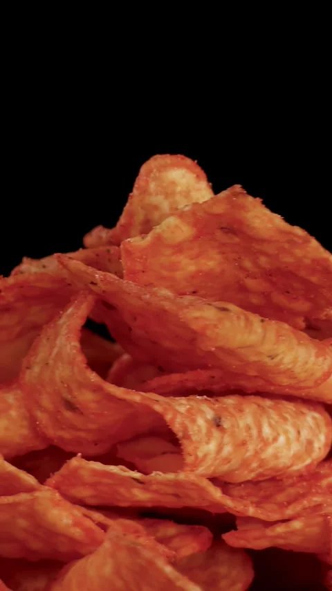 Hand Rotates Crispy Nacho Chips Against Black Background Stock Footage 321663904